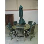 A large round garden table - diameter 180cm - with eight chairs with covers (some A/F) and parasol