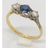 An 18ct gold and platinum diamond and sapphire three stone ring