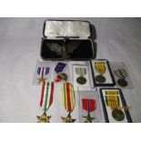 A collection of various British and American medals along with an American Eagle belt buckle