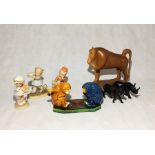A collection of ornaments and wooden animals including three Lucie Attwell figures.