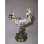 A Capodimonte porcelain centrepiece in the form of a boat with a dragon figure head ridden by a