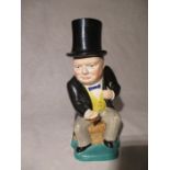 A Kirklands Embassy ware character jug, depicting seated Winston Churchill in a yellow waistcoat and