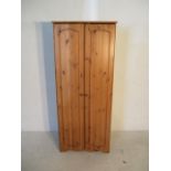 A two door pine wardrobe