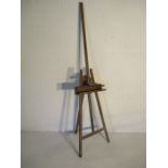 A large vintage wooden artist easel