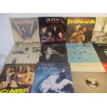 A collection of 12" vinyl records including Queen, Rod Stewart, Jimi Hendrix, Eric Clapton, Yes,