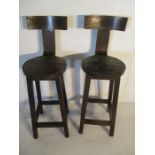 A pair of Indian style metal and wooden seated bar stools