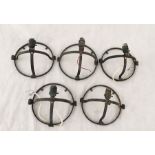 A set of five wrought iron wall lights