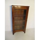 A freestanding oak display cabinet