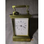 A large brass carriage clock with alarm and repeater. The white enamel dial signed H Moser Et Cie,