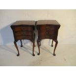 A pair of serpentine fronted bedside cabinets with three drawers and extending leaves