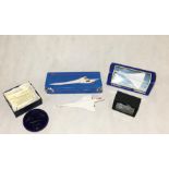 A collection of Concorde related items including a Bristol Blue Glass ltd edition paperweight