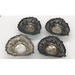 A matched set of four hallmarked silver heart shaped dishes with pierced decoration, total weight