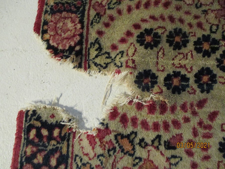 A red ground rug with floral decoration, 7 ft 2" x 4 ft 9 "- some damage to edges - Image 5 of 8