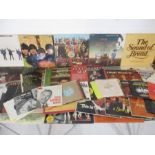 A collection of 12" vinyl records including three albums by The Beatles, Bryan Ferry, Bread, Joan