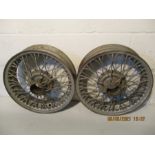 Two vintage spoked car wheels. Believed to be from an Austin Healey. 42cm x 13cm