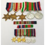 A group of five WWII medals along with the matching miniatures