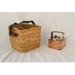 A wicker wine basket with leather strap along with a copper picnic can