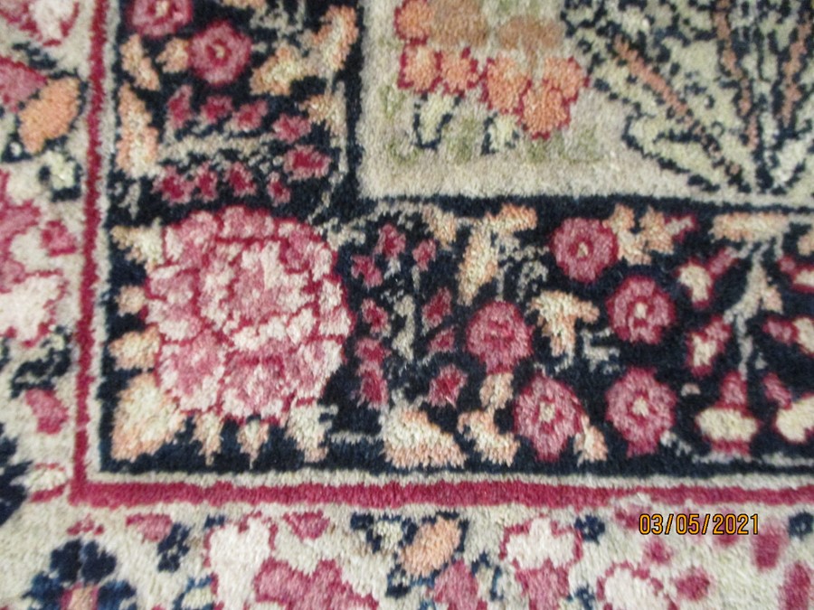 A red ground rug with floral decoration, 7 ft 2" x 4 ft 9 "- some damage to edges - Image 3 of 8