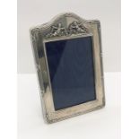 A small hallmarked silver photo frame decorated with cherubs