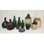 A collection of vintage bottles, stoneware cider jars etc
