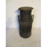 A vintage black milk churn impressed Cadbury Ltd