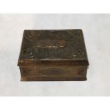 A wooden box with carved detailing showing a young woman - dated 1885