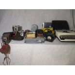 A collection of various cameras, Sperry Rand "Remington Premier" typewriter etc.