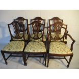 A set of six Edwardian chairs, including two carvers. Decorated with shield back and wheatsheaf