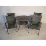 A set of four rattan effect garden chairs, along with matching table, parasol base and boxed grey
