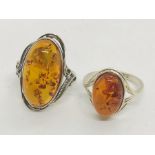 A pair of amber rings on silver