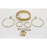 A hinged bracelet, bar brooch and St Christopher- all 9ct gold along with unmarked hoop earrings-