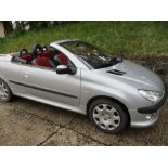 A 2003 Peugeot 206 Automatic coupe, 1600cc, 56343 miles, electric retractable roof, red and black