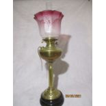 A brass oil lamp ( converted) with cranberry glass shade