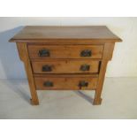 A small pine chest of three drawers