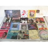 A collection of 7" vinyl records including Alice Copper, Billy Joel, Rainbow, Madonna, Whitesnake,