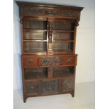 A Victorian oak bookcase with carved decoration - height 202cm, width 128cm, depth 52cm
