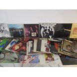 A collection of 12" vinyl records including The Beatles, Rolling Stones, The Eagles, Alexis Korner'