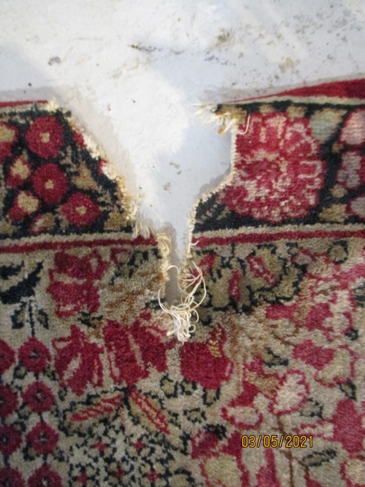 A red ground rug with floral decoration, 7 ft 2" x 4 ft 9 "- some damage to edges - Image 7 of 8