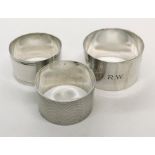 Three silver serviette rings