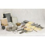 A collection of silver plated items, cutlery, photo frames etc