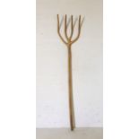 A rustic wooden pitchfork