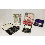 A collection of silver plated items including trumpet vases, spoons, etc
