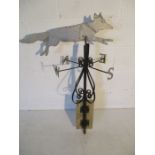 A wrought iron weathervane in the form of a fox