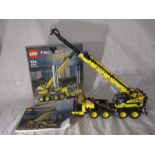 A completed Lego Technic Mobile Crane (42108) with original box and instructions