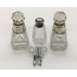 Three small scent bottles, two with silver collars and the other with silver lid along with a