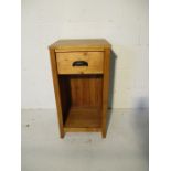 A bedside cabinet with single drawer