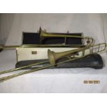 A Boosey & Hawkes "Emperor" brass trombone in case along with one other