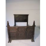 A heavily carved oak 4ft bed with heraldic lion finials