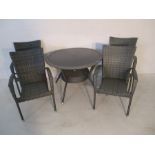 A set of four rattan effect garden chairs, along with matching table, parasol base and boxed grey