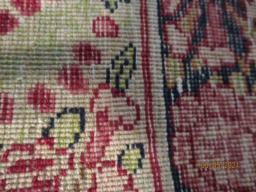 A red ground rug with floral decoration, 7 ft 2" x 4 ft 9 "- some damage to edges - Image 4 of 8